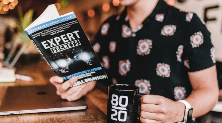 Confident young professional man smiling in a modern office setting, wearing business casual attire