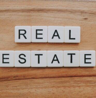 Real estate property for sale, featuring a modern house with a spacious front yard and well-maintained landscaping