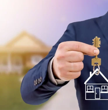 Real estate agent holding keys in front of a newly sold modern home with a welcoming exterior