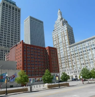 Downtown Tulsa, Oklahoma skyline with modern buildings, the Tulsa Performing Arts Center, and the Arkansas River in the background