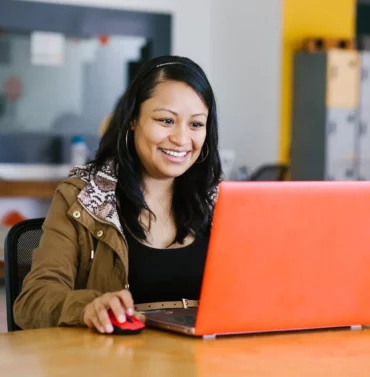 Professional businesswoman working at her desk with a laptop and documents in a modern office