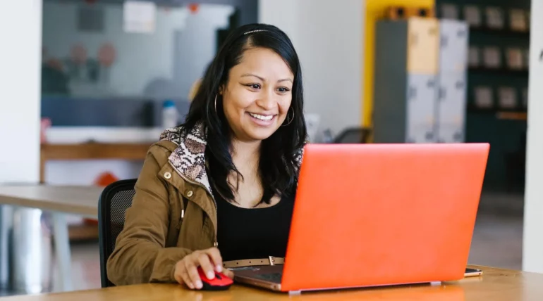 Professional businesswoman working at her desk with a laptop and documents in a modern office