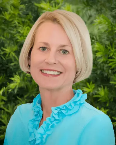 Charlene Pryor, Chief Financial Officer of VRET, in professional attire, smiling confidently